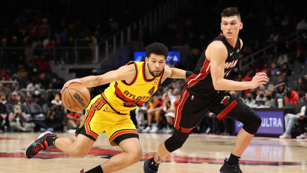 Jan 12, 2022; Atlanta, Georgia, USA; Atlanta Hawks guard Skylar Mays (4) drives against Miami Heat guard Tyler Herro (14) during the fourth quarter at State Farm Arena.